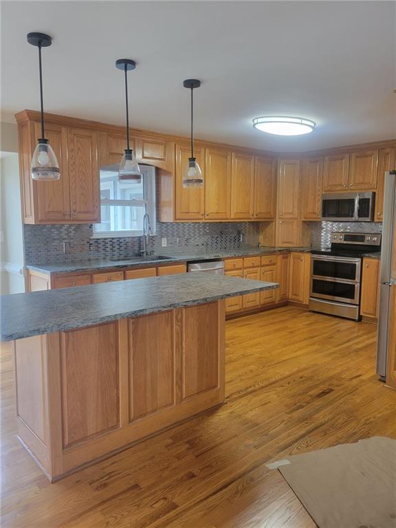3370 Westbrook Road Suwanee, GA 30024 - Photo 22 of 43 a kitchen with stainless steel appliances granite countertop a sink a stove and a wooden floors