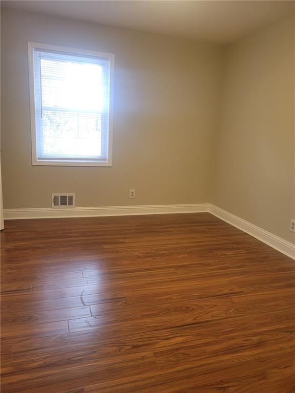3370 Westbrook Road Suwanee, GA 30024 - Photo 24 of 43 a view of an empty room with wooden floor and a window