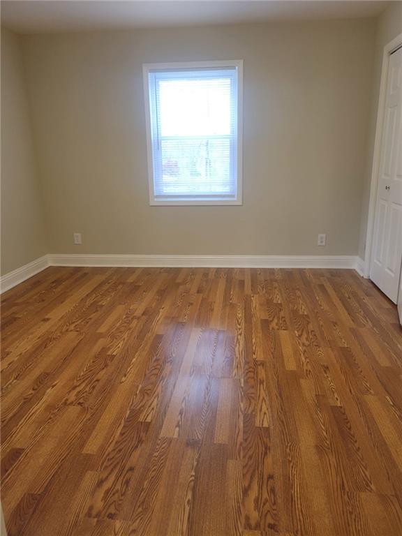 3370 Westbrook Road Suwanee, GA 30024 - Photo 26 of 43 an empty room with wooden floor and windows