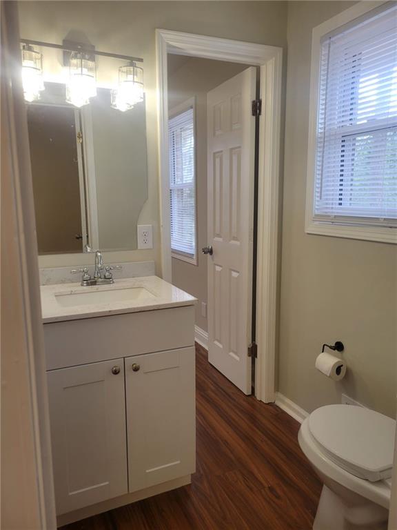 3370 Westbrook Road Suwanee, GA 30024 - Photo 33 of 43 a bathroom with a toilet a sink and mirror
