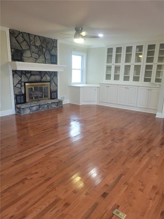 3370 Westbrook Road Suwanee, GA 30024 - Photo 35 of 43 an empty room with wooden floor fireplace and windows