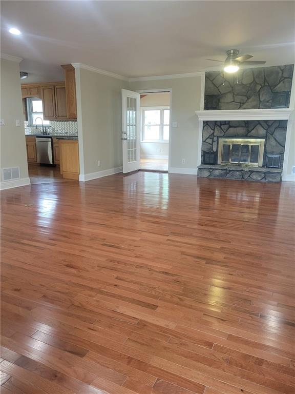 3370 Westbrook Road Suwanee, GA 30024 - Photo 37 of 43 an empty room with wooden floor and kitchen view