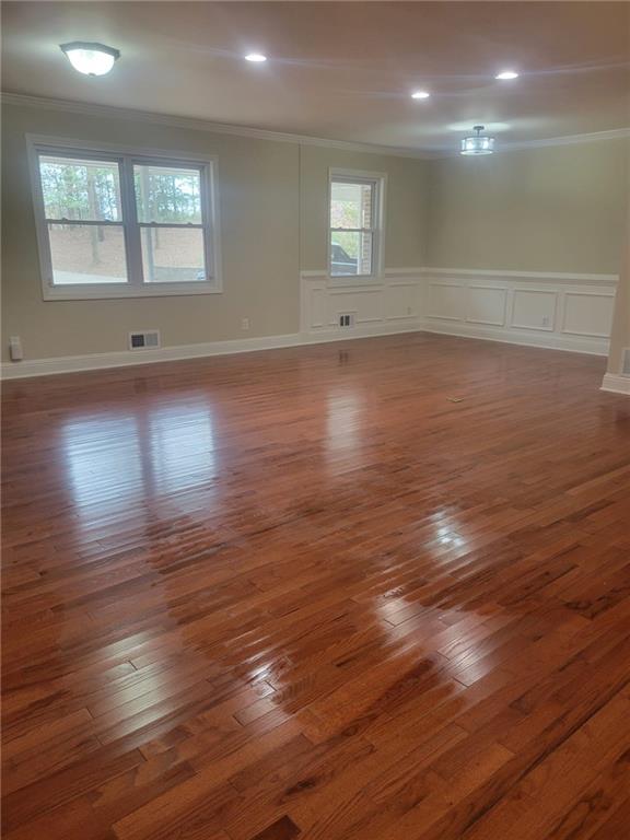 3370 Westbrook Road Suwanee, GA 30024 - Photo 8 of 43 an empty room with wooden floor and windows