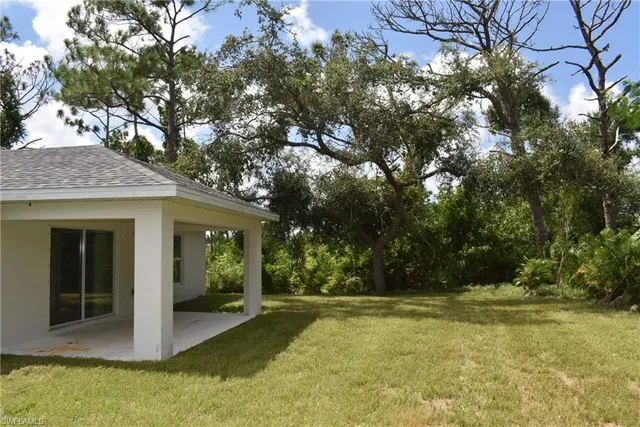 a view of house with backyard
