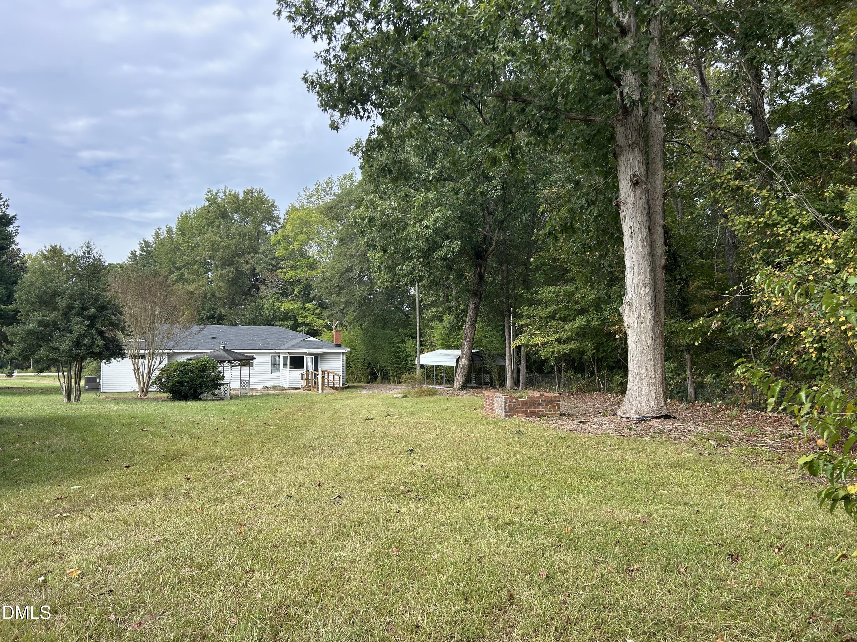 11114 Cleveland Road Garner, NC 27529 - Photo 11 of 26 a house with trees in front of it