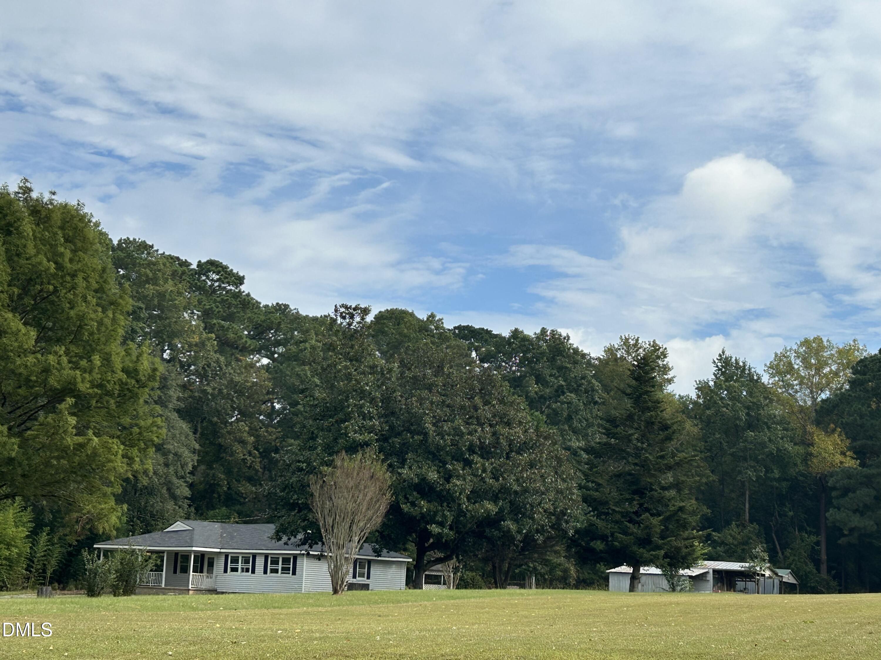 11114 Cleveland Road Garner, NC 27529 - Photo 15 of 26 a view of a swimming pool with seating area and trees in the background
