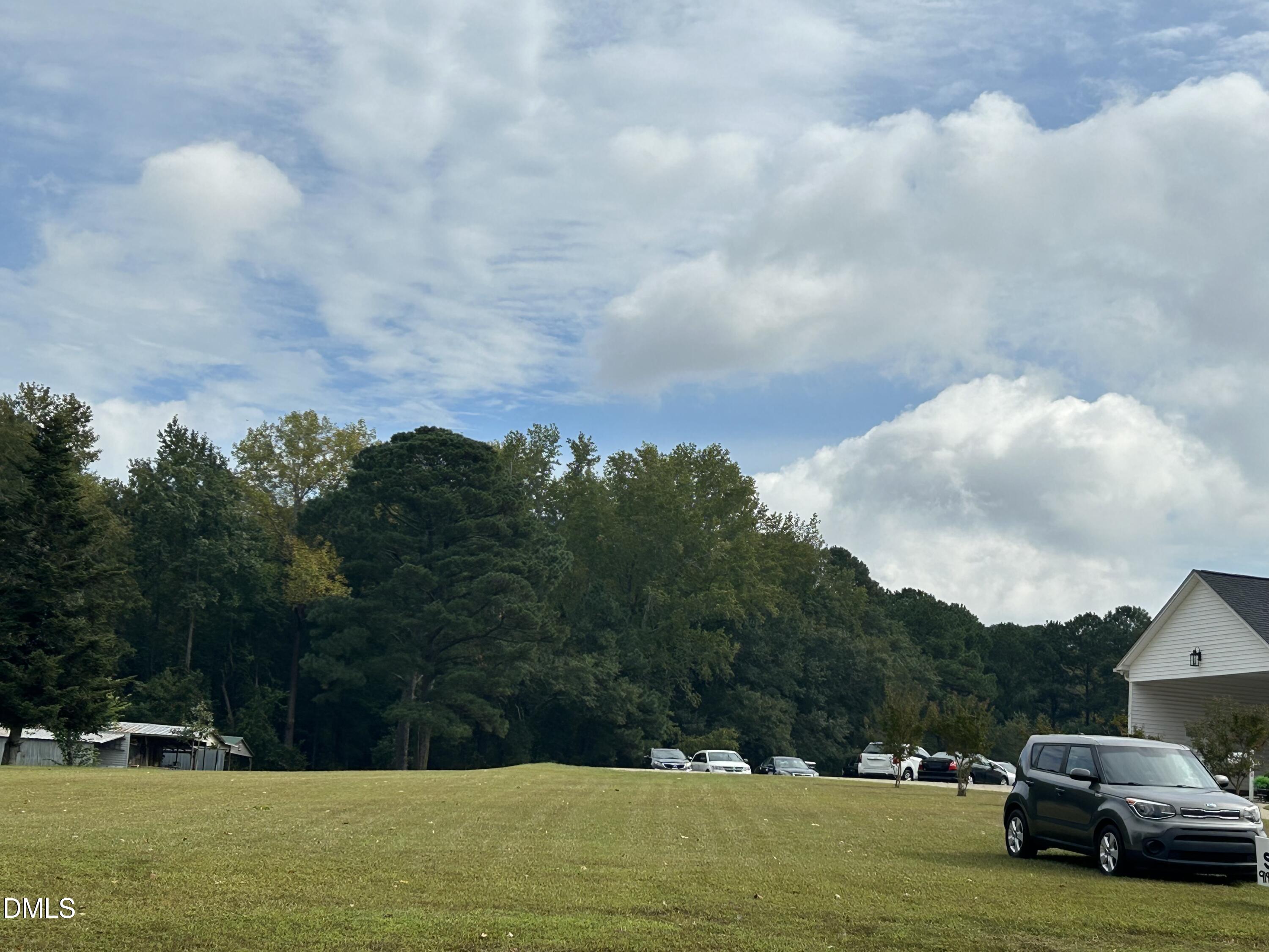 11114 Cleveland Road Garner, NC 27529 - Photo 16 of 26 a view of car parked in middle of green field