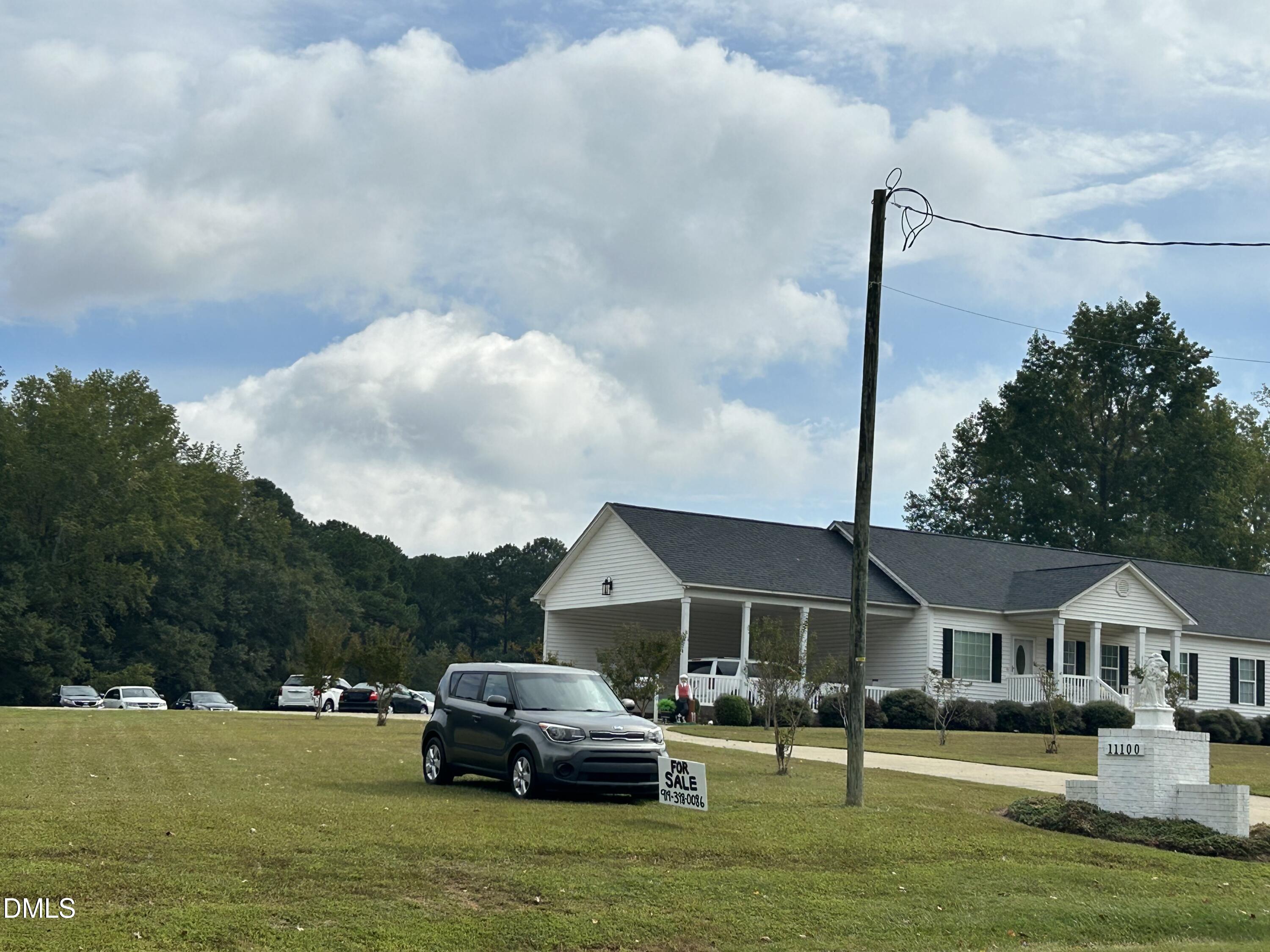 11114 Cleveland Road Garner, NC 27529 - Photo 17 of 26 a front view of a house with a garden and trees