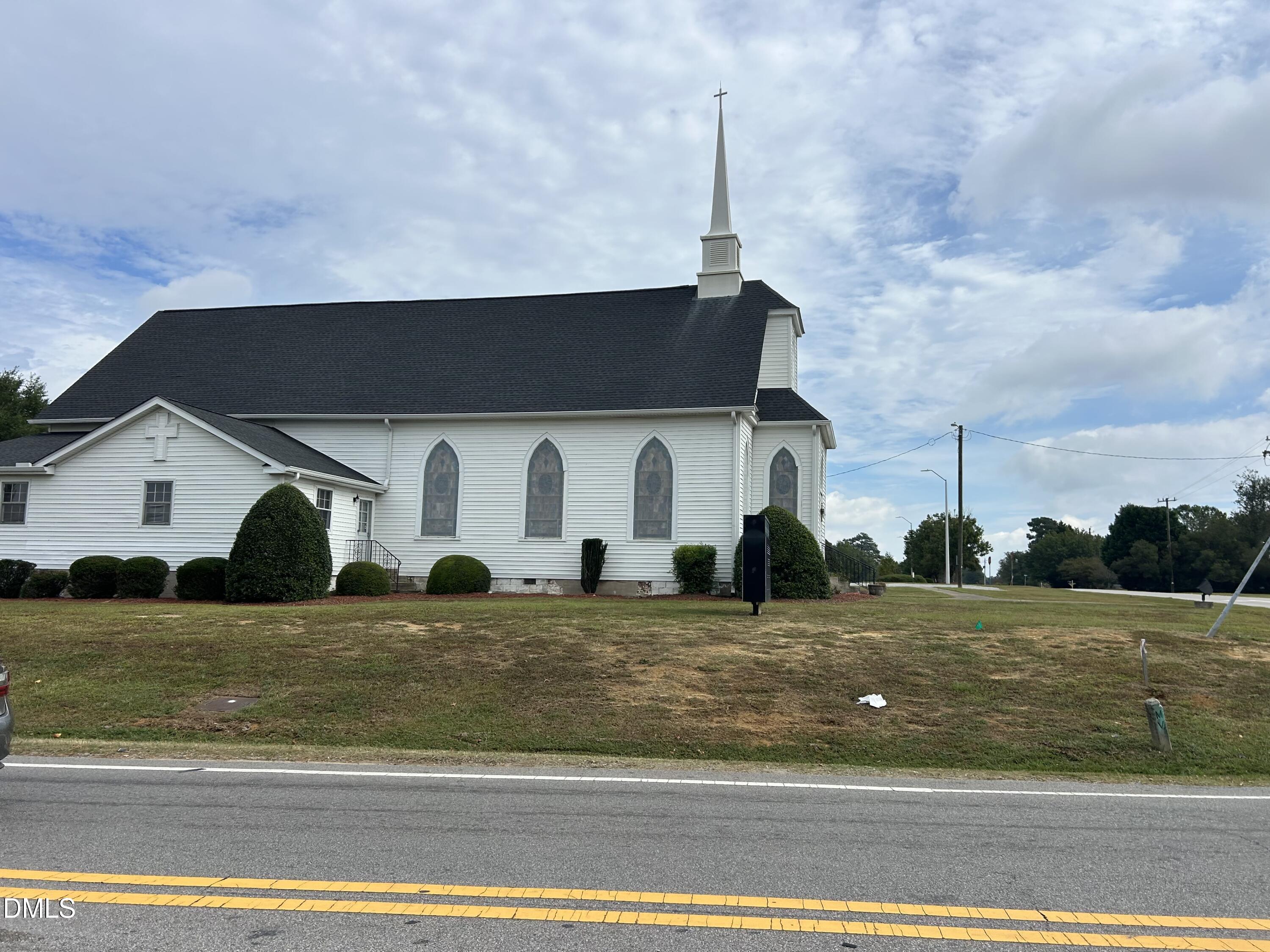 11114 Cleveland Road Garner, NC 27529 - Photo 23 of 26 a front view of a house with a garden and plants