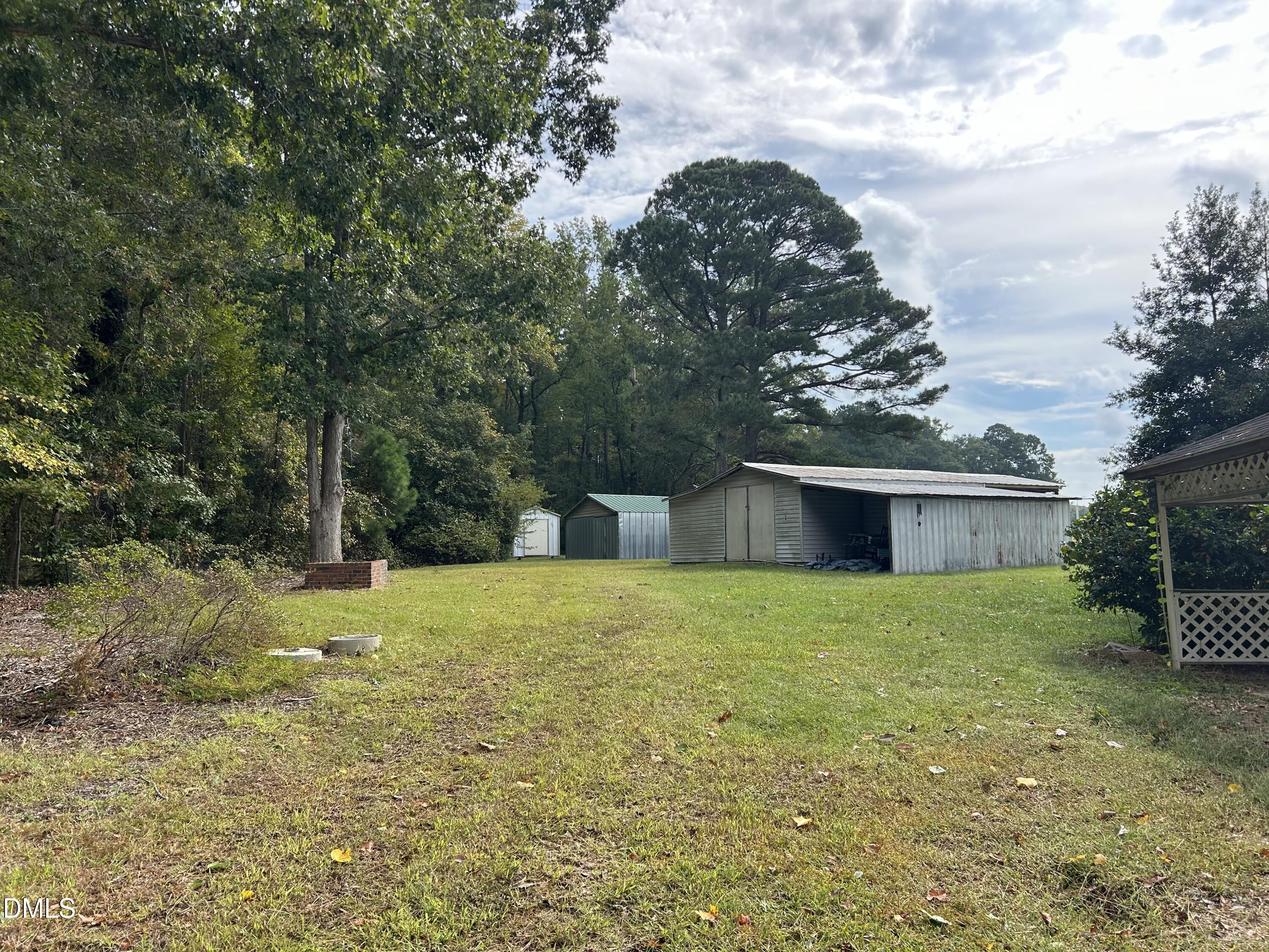 11114 Cleveland Road Garner, NC 27529 - Photo 6 of 26 a house with trees in front of it