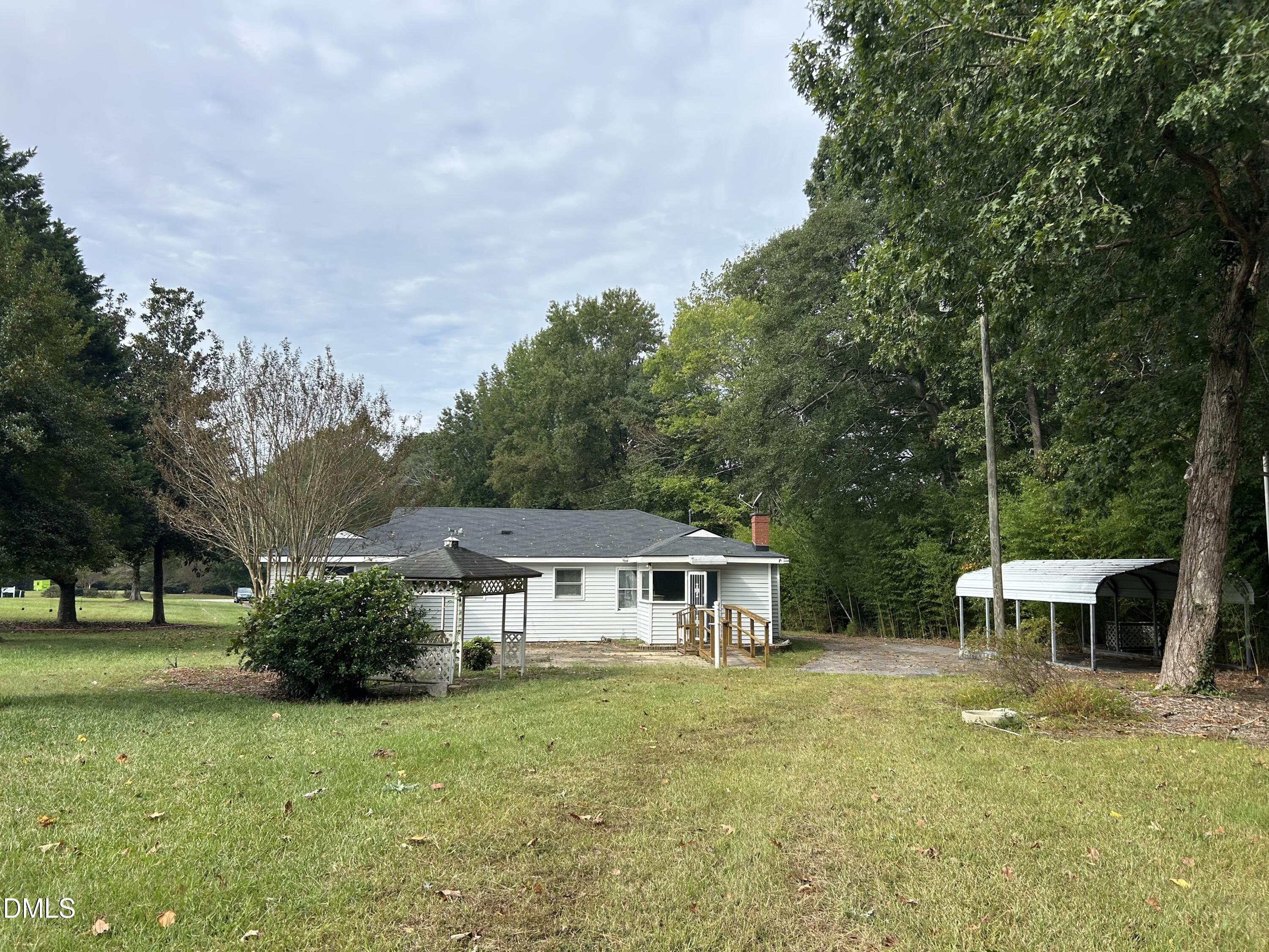 11114 Cleveland Road Garner, NC 27529 - Photo 8 of 26 a front view of a house with garden and trees