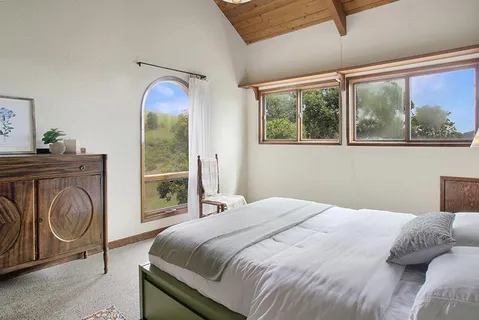 a bedroom with a bed and a window