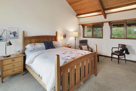 a bed sitting in a bedroom next to a window