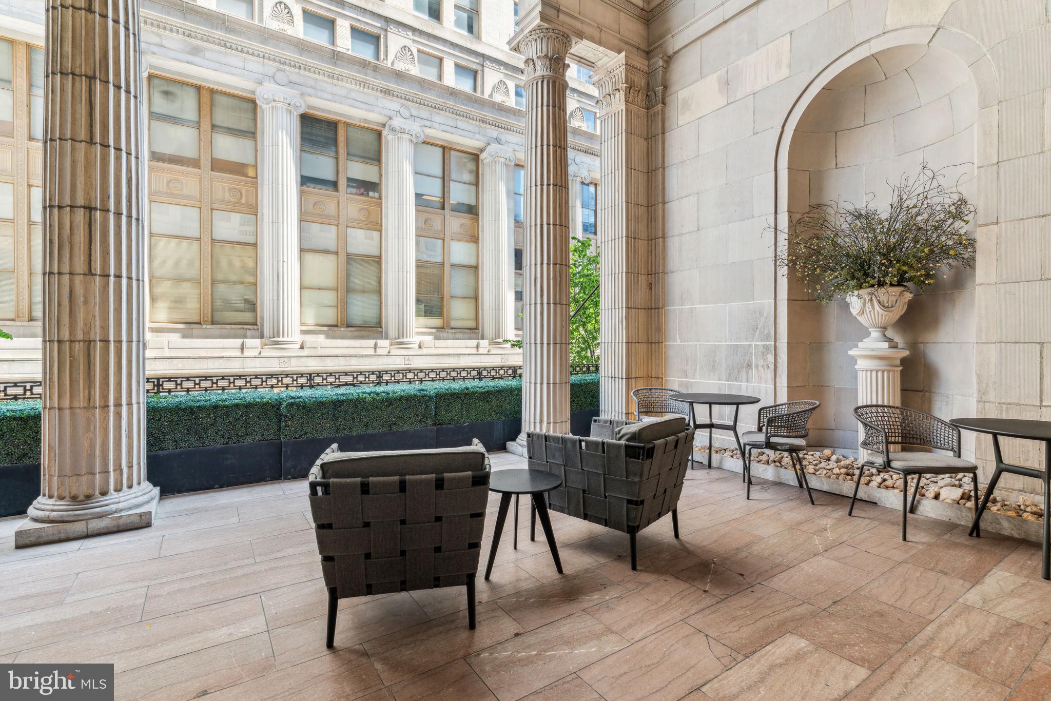 875 Sansom Street, Unit 913 Philadelphia, PA 19107 - Photo 31 of 35 a view of a patio with couple of chairs and a fountain