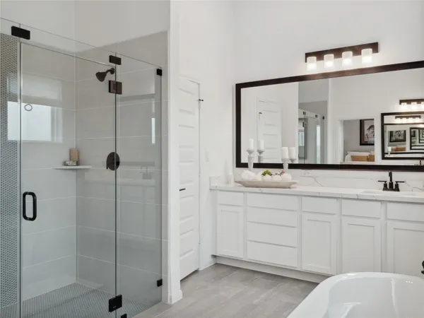 a bathroom with a double vanity sink mirror and shower