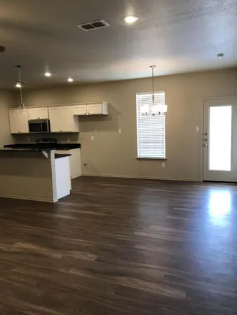 an open kitchen with a sink and dish washer
