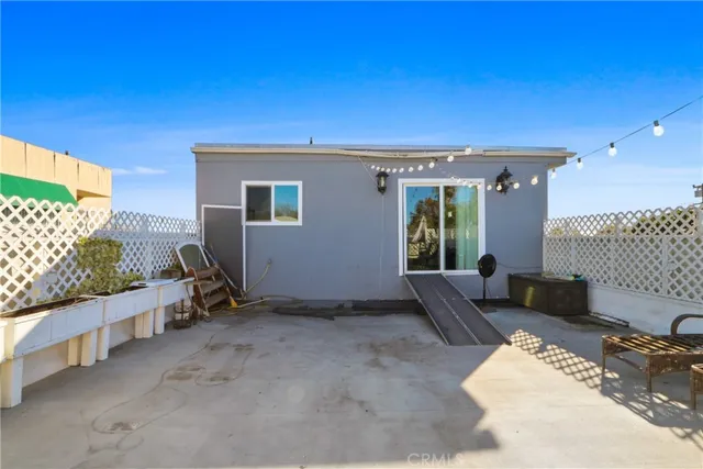 a view of a livingroom with furniture and floor to ceiling window