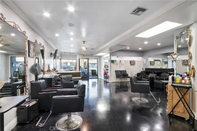 a living room with lots of furniture and kitchen view