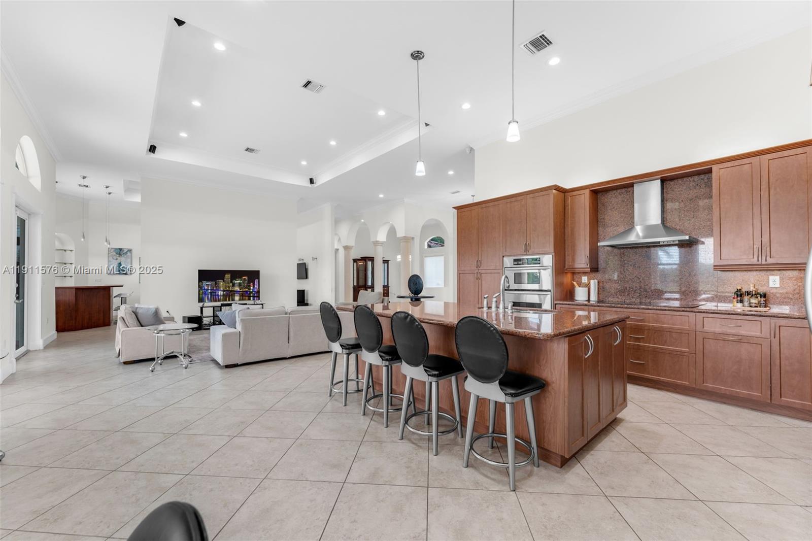 15050 Southwest 179th Avenue Miami, FL 33196 - Photo 11 of 46 a large kitchen with kitchen island a sink a counter top stainless steel appliances and cabinets