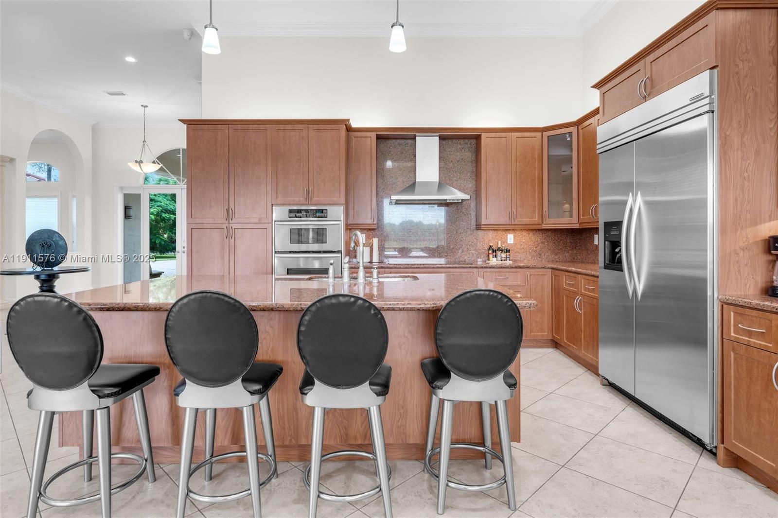 15050 Southwest 179th Avenue Miami, FL 33196 - Photo 12 of 46 a kitchen with granite countertop a counter space chairs appliances and cabinets