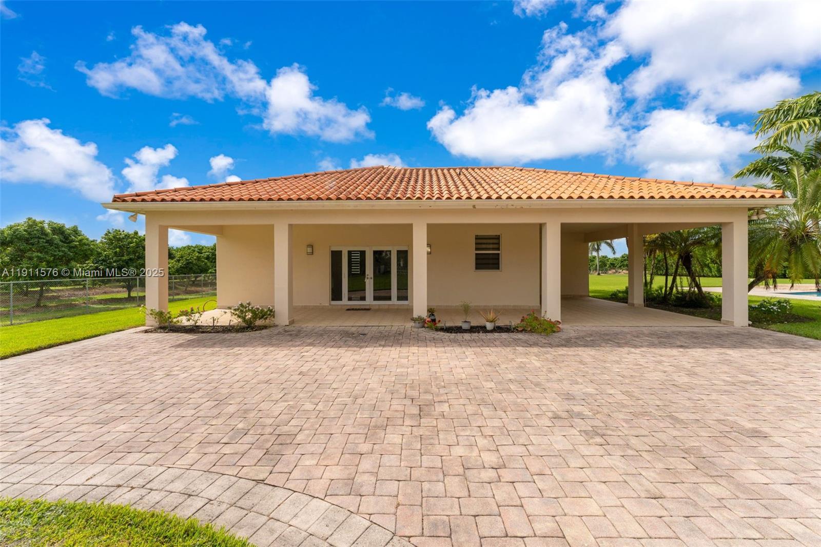 15050 Southwest 179th Avenue Miami, FL 33196 - Photo 31 of 46 a view of a house with a yard and potted plants