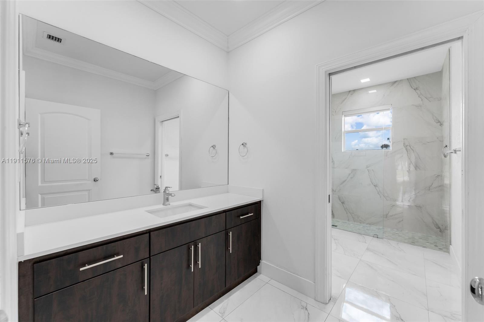 15050 Southwest 179th Avenue Miami, FL 33196 - Photo 40 of 46 a bathroom with a shower sink and mirror