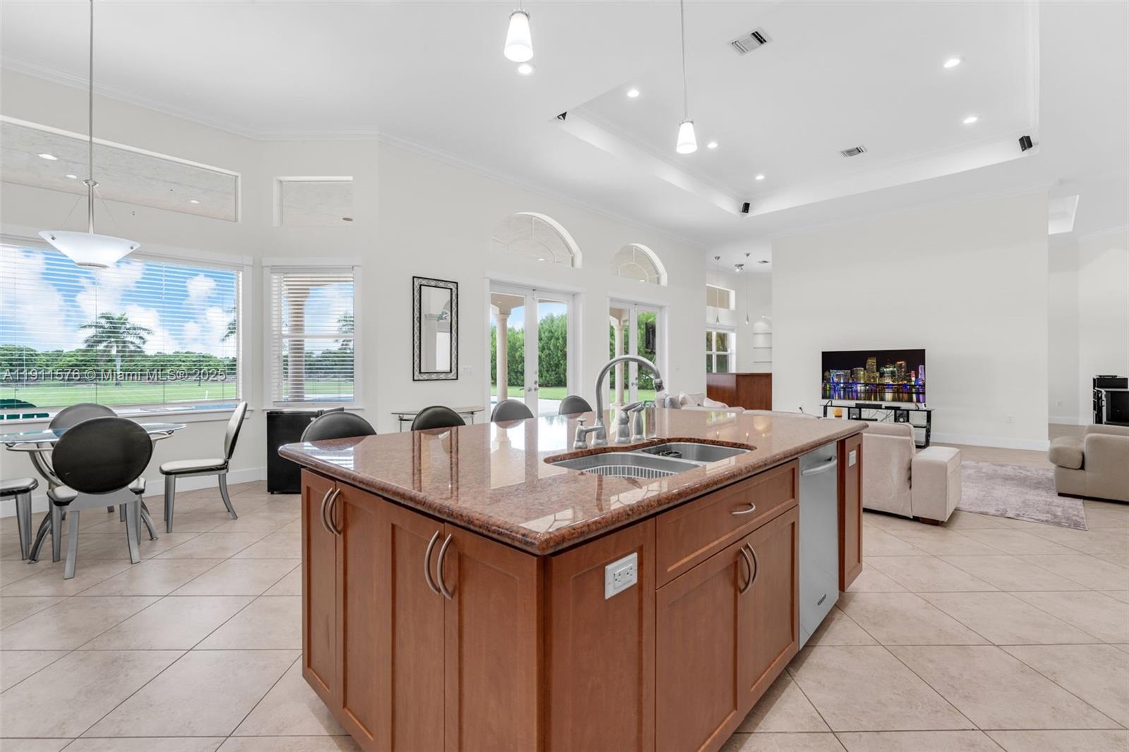 15050 Southwest 179th Avenue Miami, FL 33196 - Photo 10 of 46 a kitchen with stainless steel appliances granite countertop a sink and a refrigerator