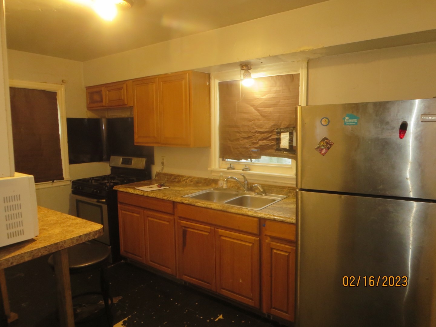 1224 East Chestnut Street Kankakee, IL 60901 - Photo 4 of 10 a kitchen with stainless steel appliances a refrigerator and a stove