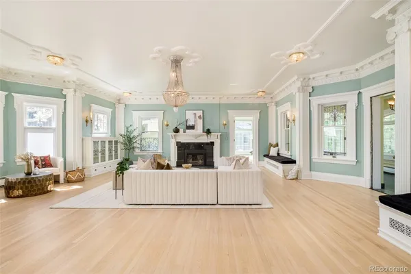 a living room with furniture a fireplace and a large window