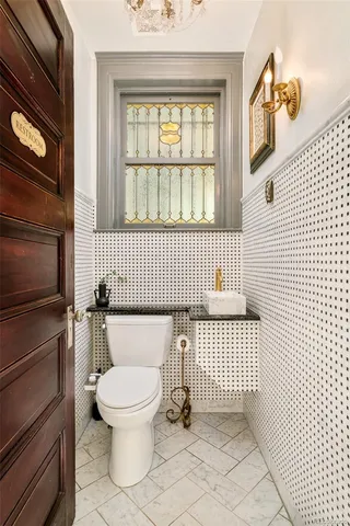 a kitchen with stainless steel appliances a table chairs and a refrigerator
