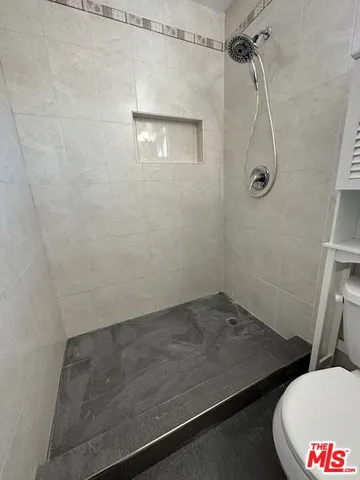 a bathroom with a sink toilet and a mirror