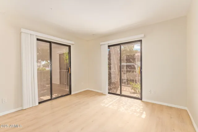 an empty room with windows and closet