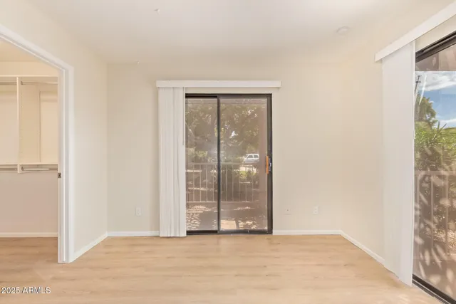 a view of an empty room with glass door