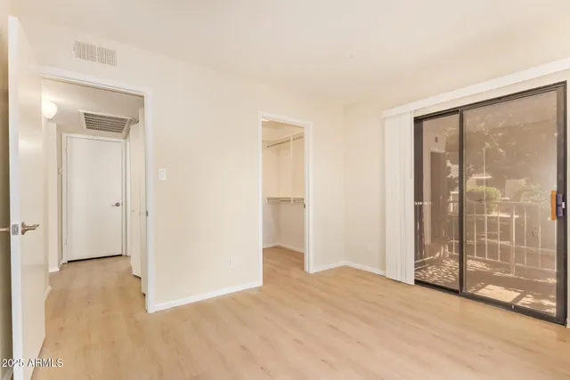 a view of an empty room with glass door