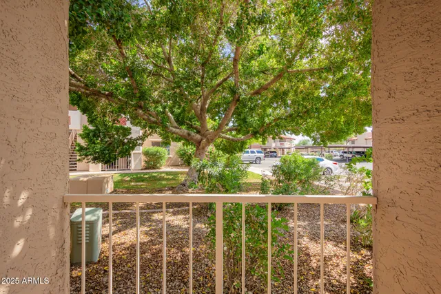 a view of a balcony with trees