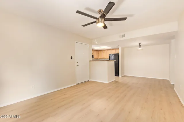 a view of a kitchen with a refrigerator and a ceiling fan