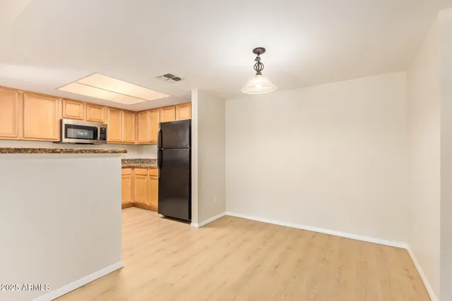 a kitchen with refrigerator and microwave