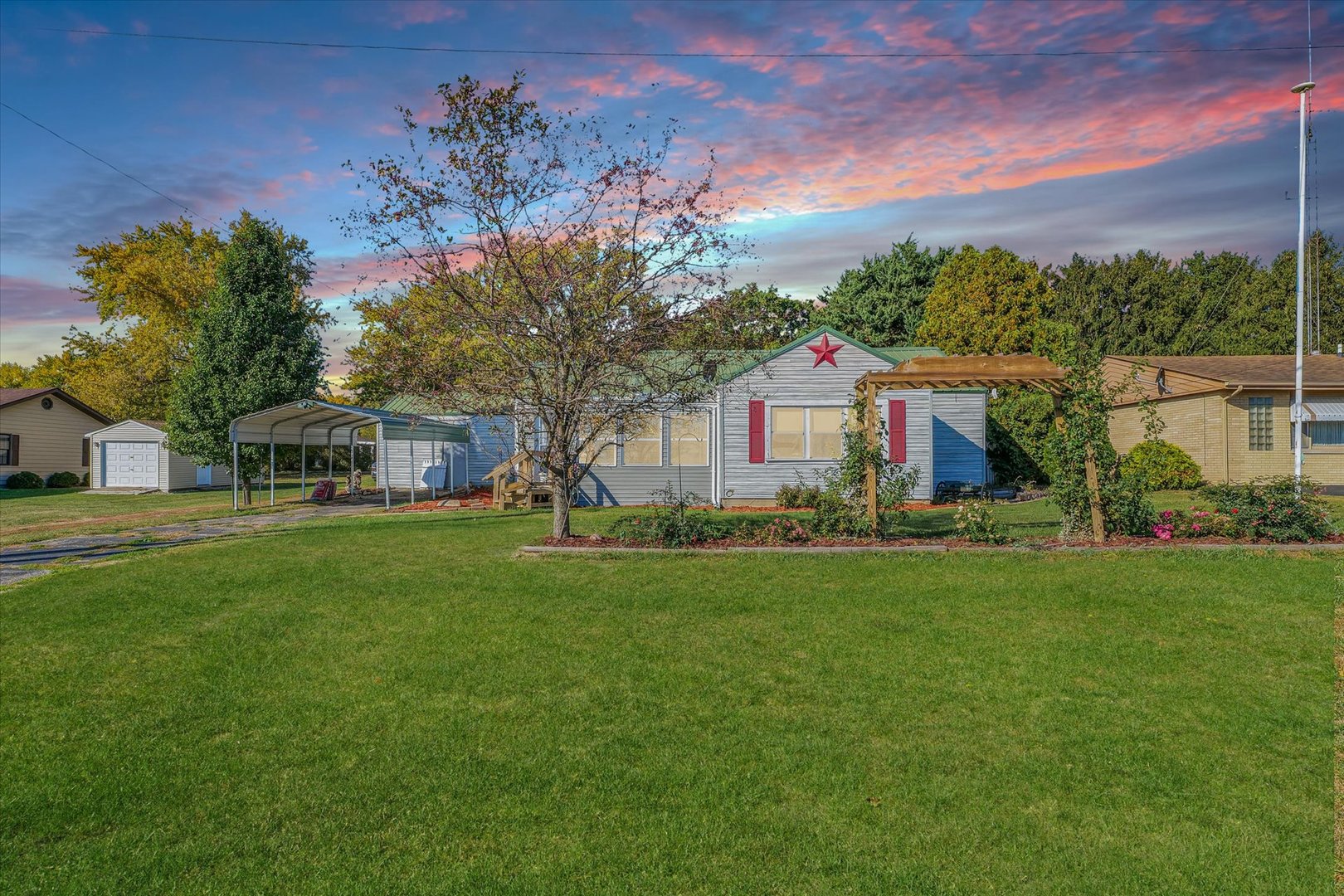 a front view of house with yard and green space