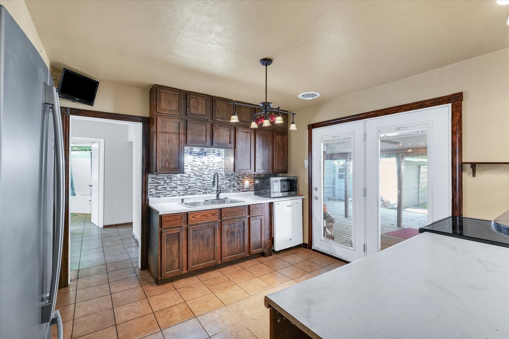 309 South Main Street Elliott, IL 60933 - Photo 16 of 44 a kitchen with kitchen island cabinets and refrigerator