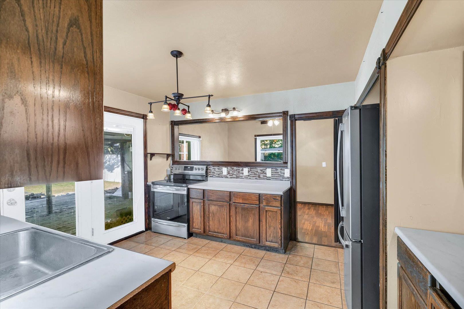 309 South Main Street Elliott, IL 60933 - Photo 17 of 44 a kitchen with stainless steel appliances granite countertop a sink and a refrigerator