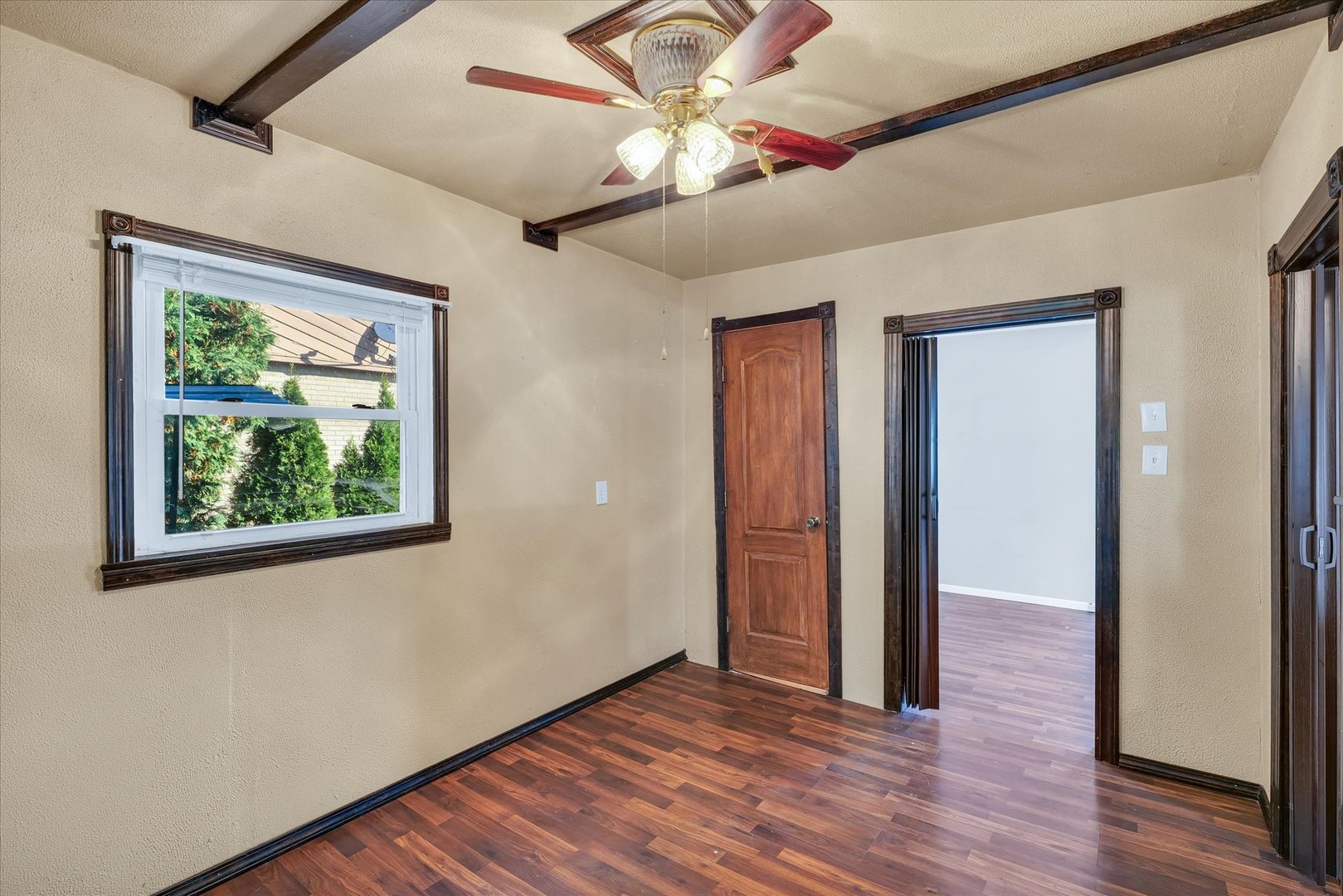 309 South Main Street Elliott, IL 60933 - Photo 24 of 44 an empty room with wooden floor chandelier fan and windows