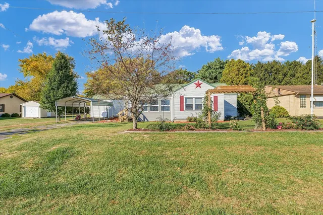 a front view of a house with a big yard