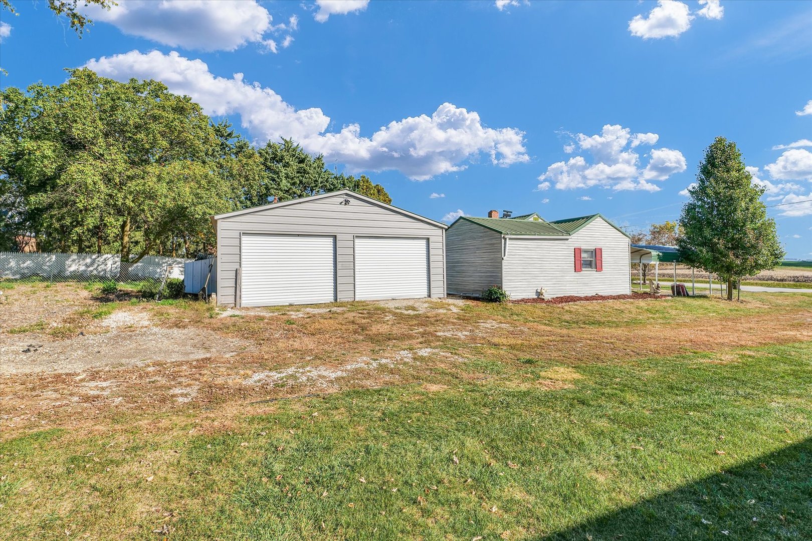 309 South Main Street Elliott, IL 60933 - Photo 5 of 44 a front view of a house with a yard and garage