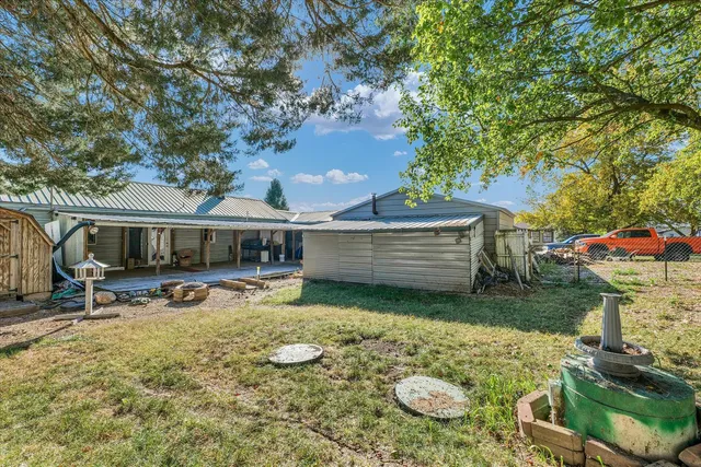 a view of a house with backyard and sitting area