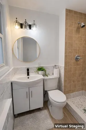 a bathroom with a toilet a sink and mirror