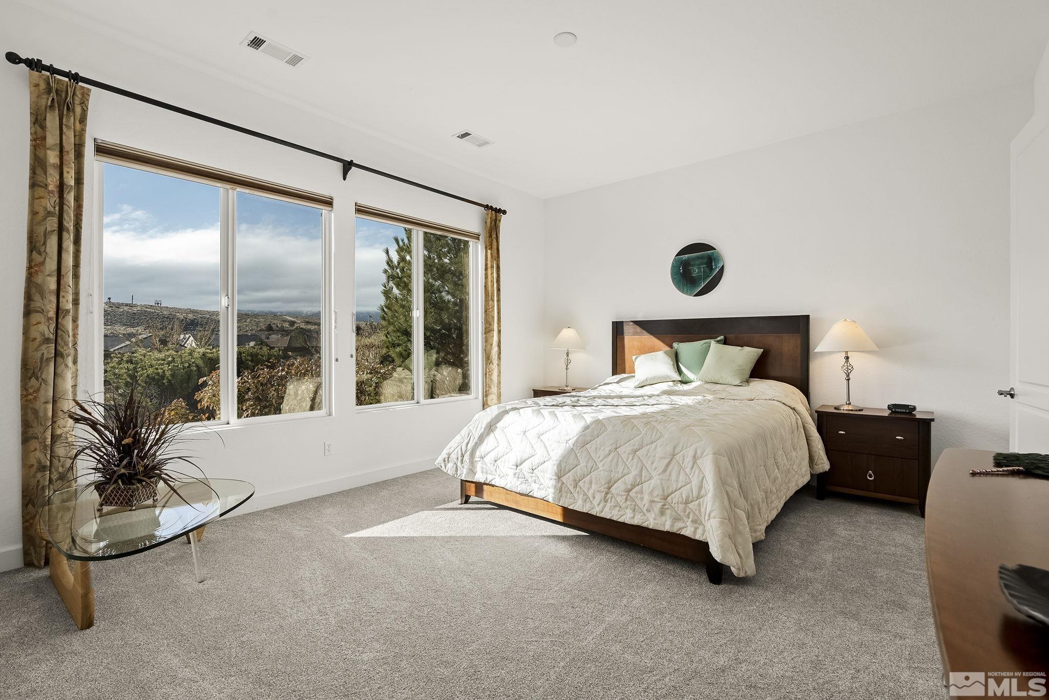 1455 Meridian Ranch Drive Reno, NV 89523 - Photo 14 of 33 a spacious bedroom with a bed and glass window