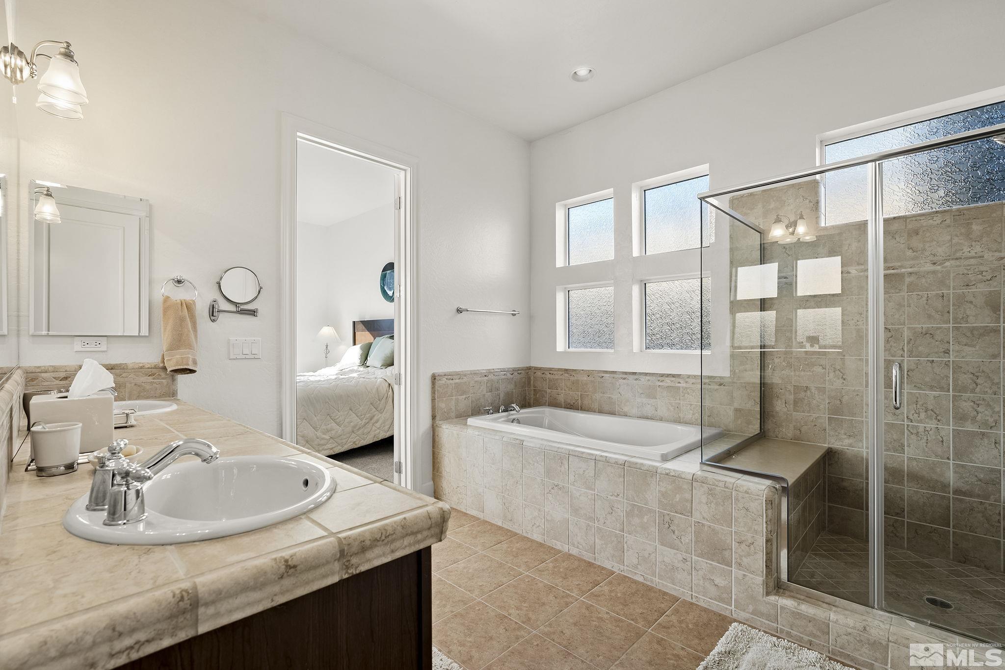 1455 Meridian Ranch Drive Reno, NV 89523 - Photo 17 of 33 a bathroom with a sink tub shower and a mirror