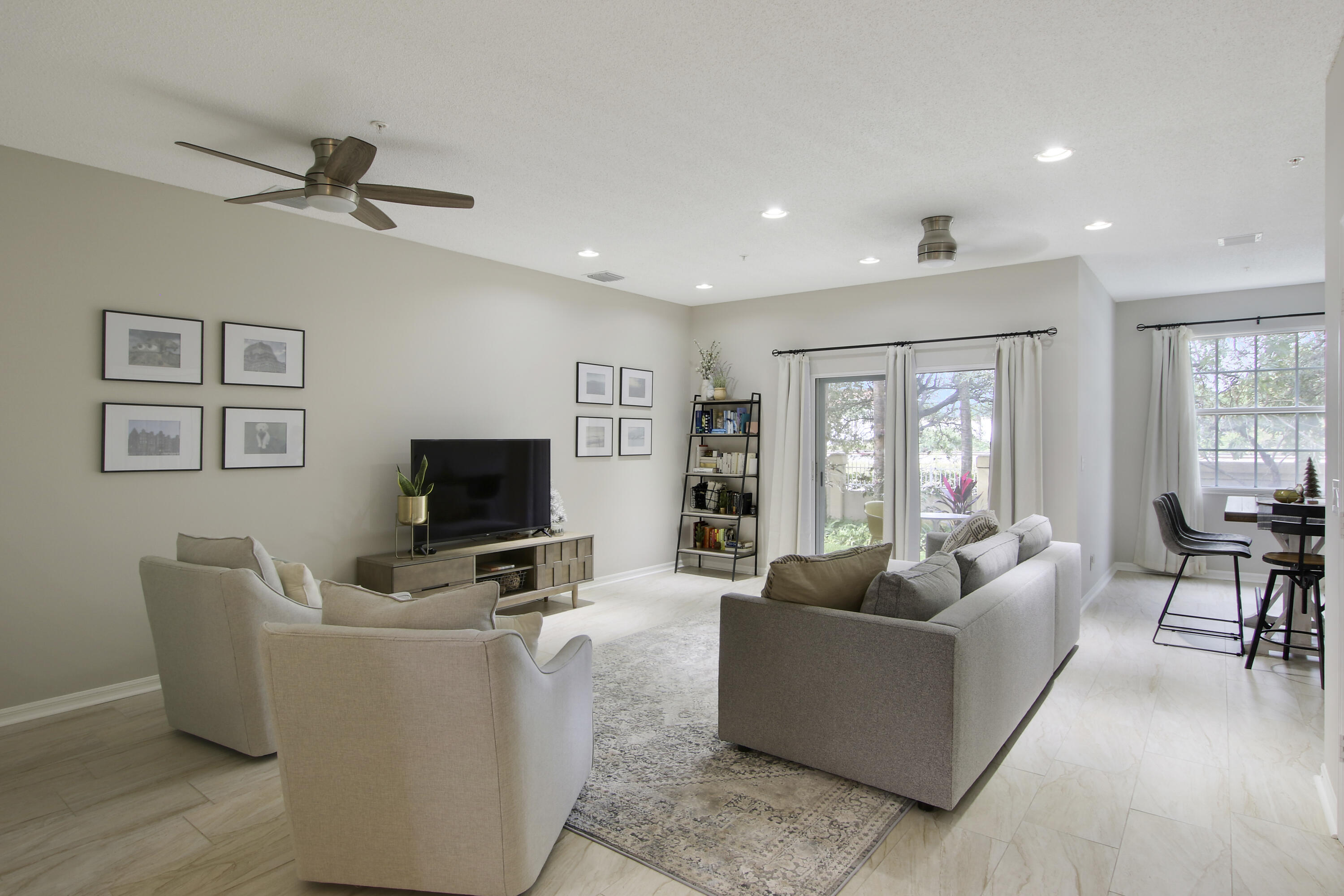 115 Lighthouse Circle, Unit D Tequesta, FL 33469 - Photo 12 of 28 a living room with furniture and a flat screen tv