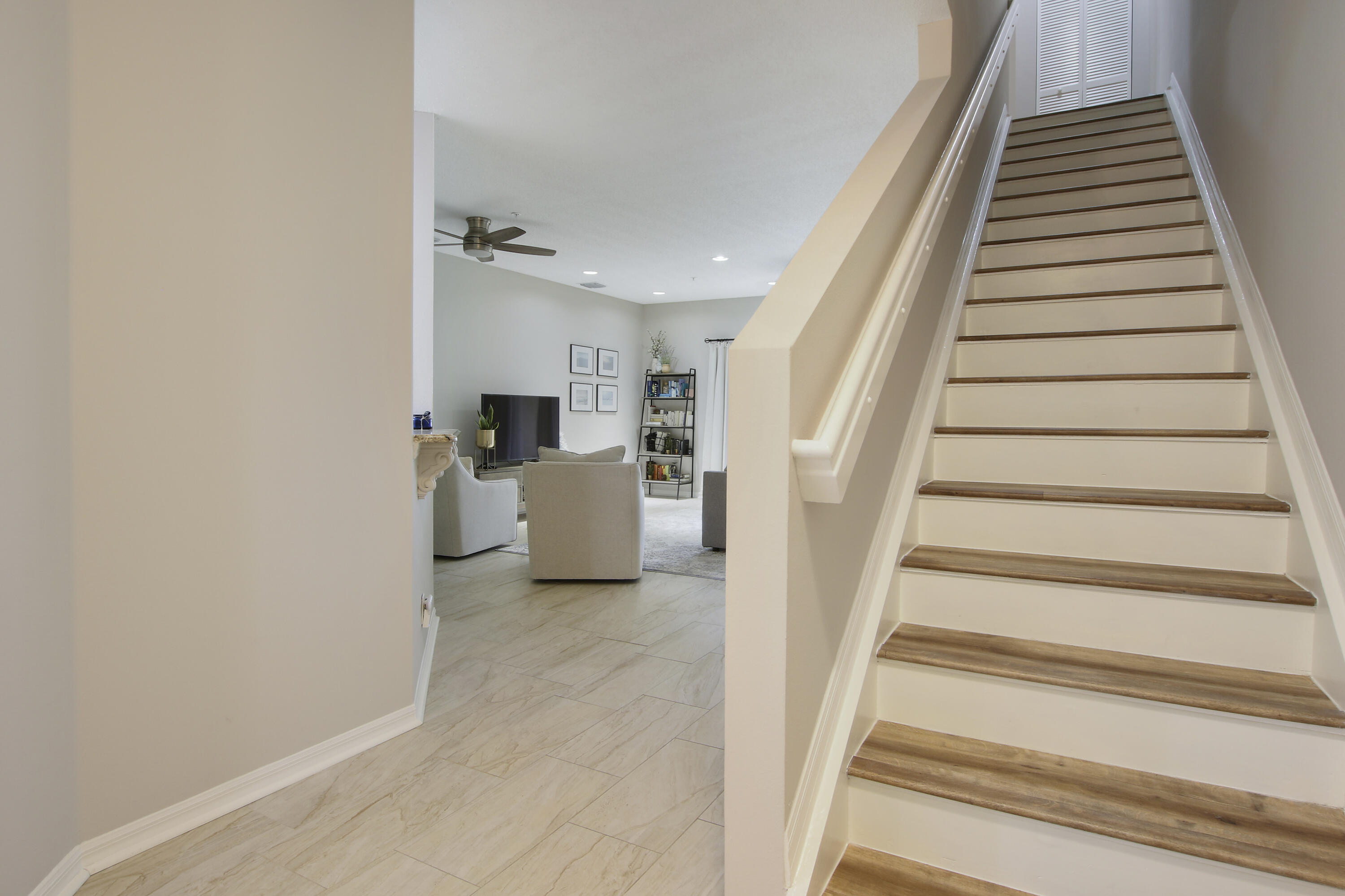 115 Lighthouse Circle, Unit D Tequesta, FL 33469 - Photo 16 of 28 a view of a hallway with staircase and white walls