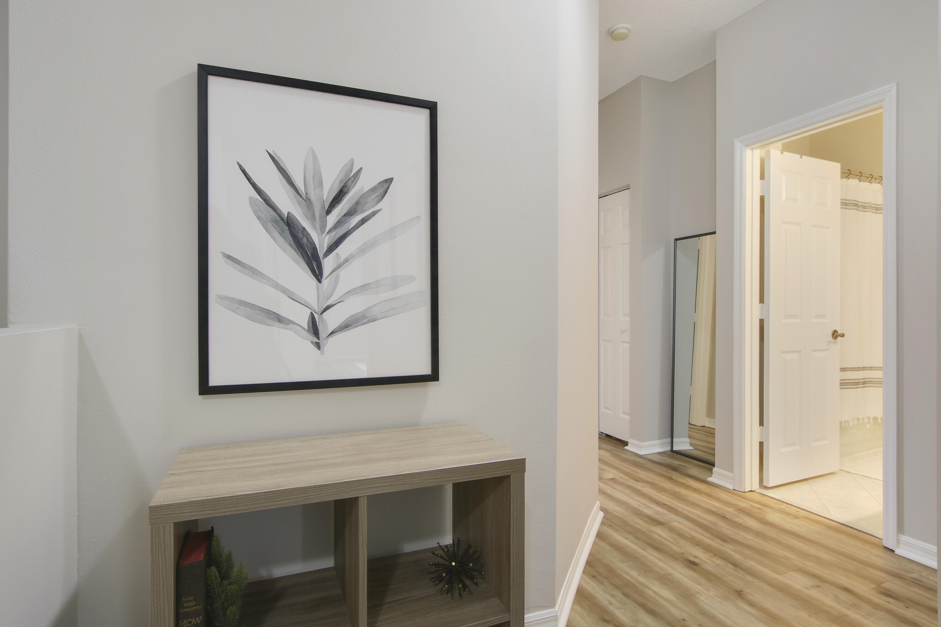 115 Lighthouse Circle, Unit D Tequesta, FL 33469 - Photo 17 of 28 a view of a hallway with paintings on the wall
